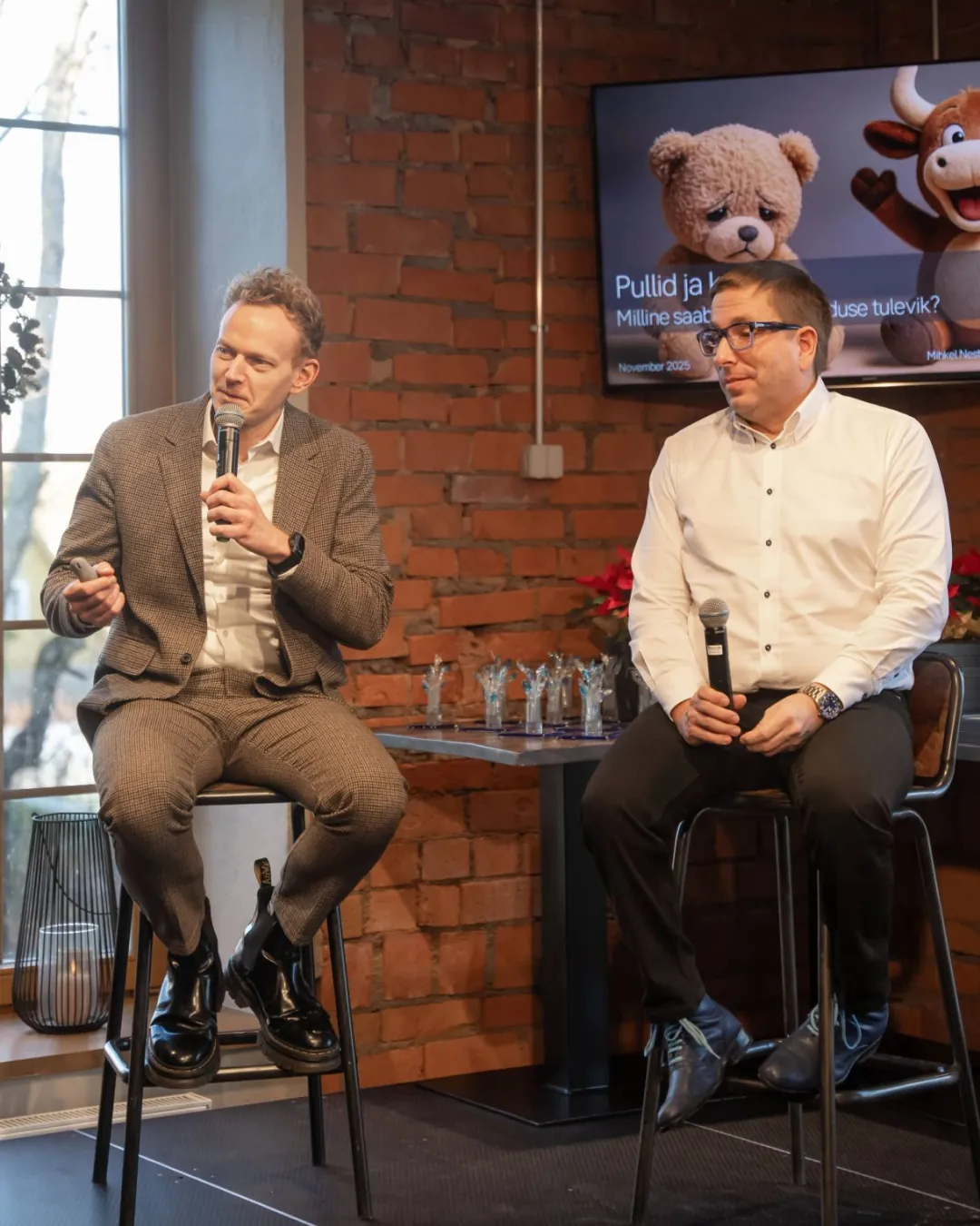 Mihkel Nestor speaking on stage at a live event